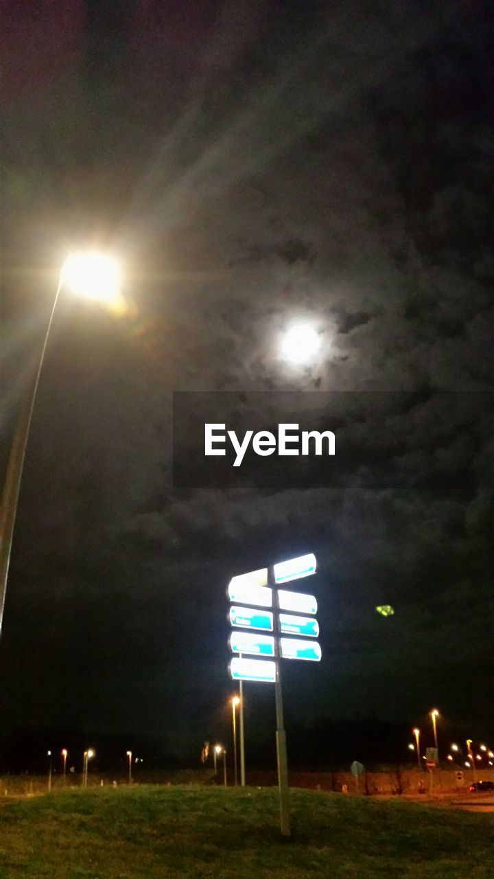 VIEW OF ILLUMINATED STREET LIGHT AGAINST SKY AT NIGHT