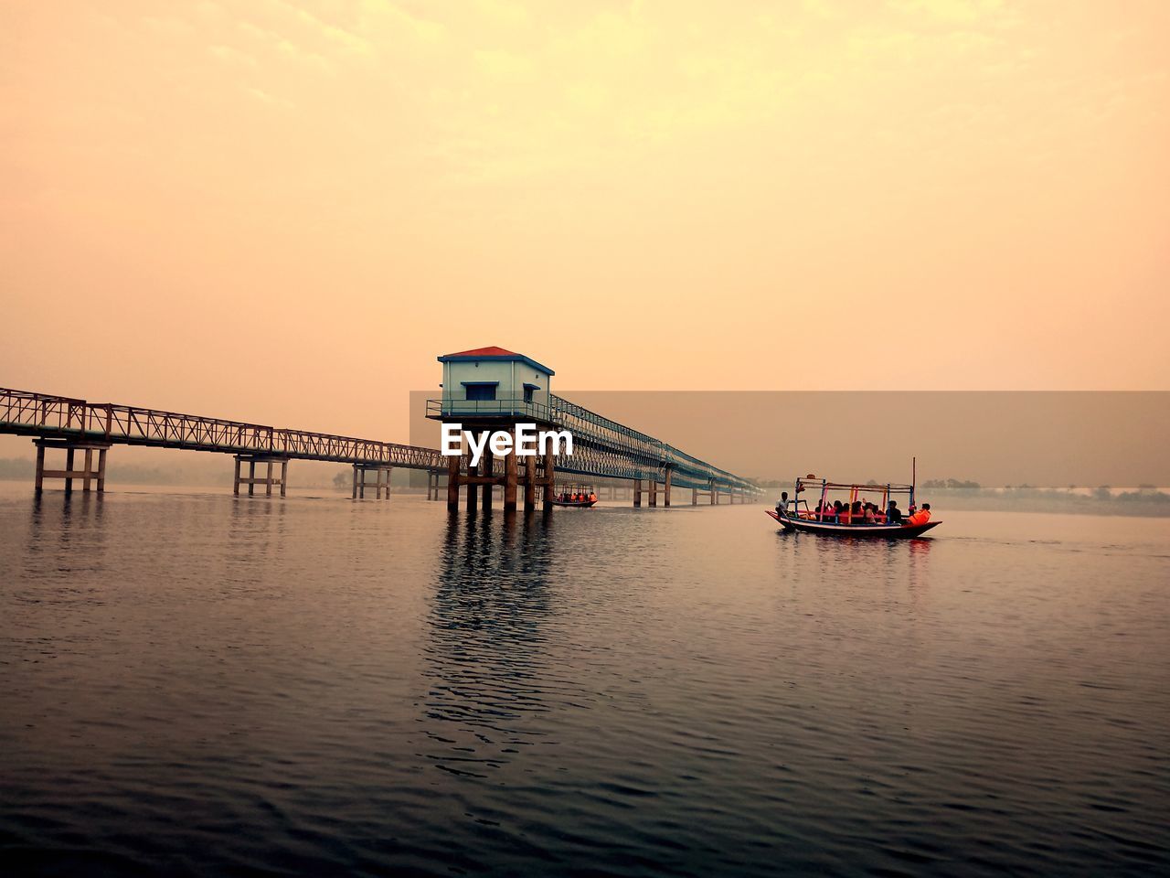 Scenic view of pier on sea against sky during sunset