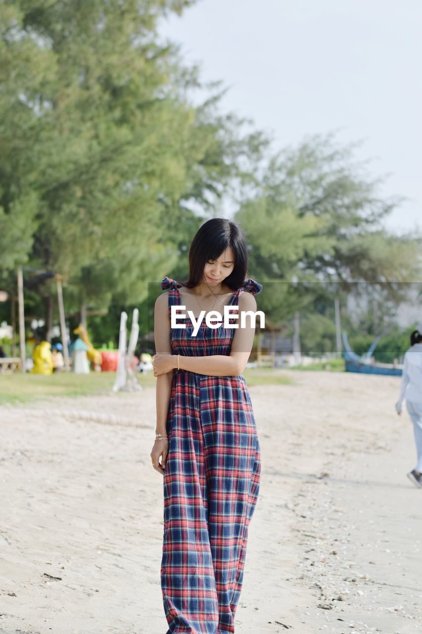 Full length of young woman standing on land