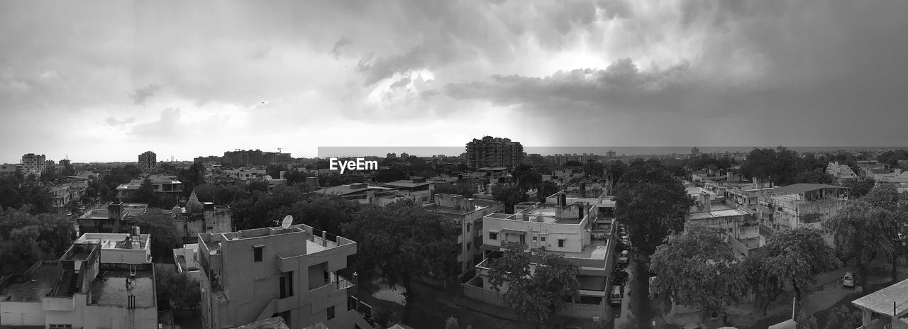 High angle shot of townscape against clouds