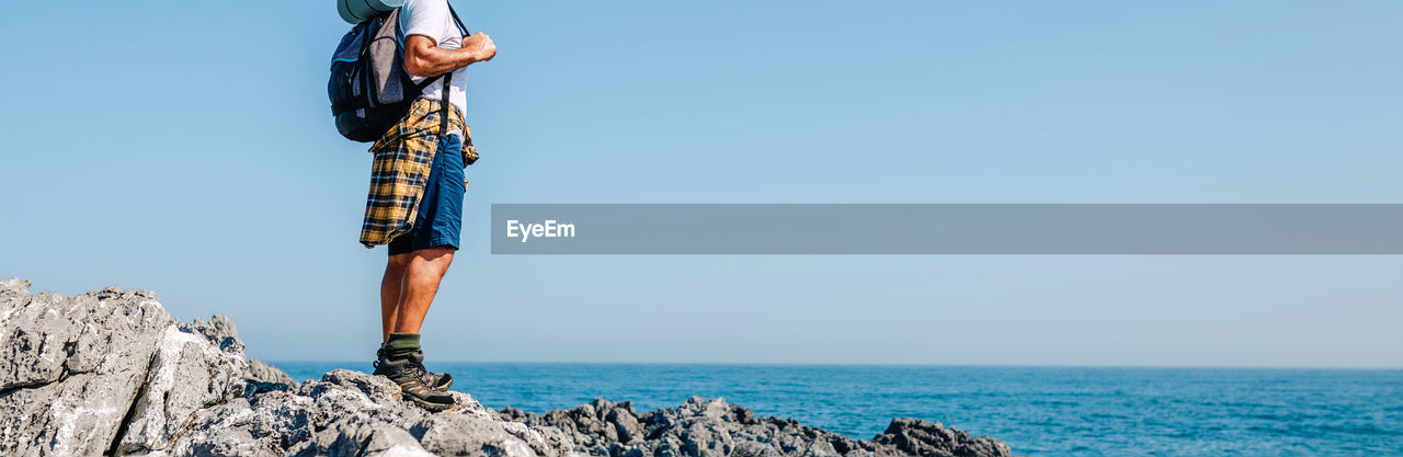 Senior man hiking looking at sea landscape