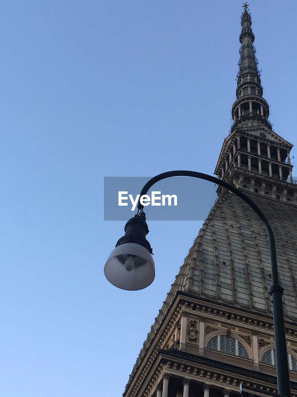 Low angle view of street light against building