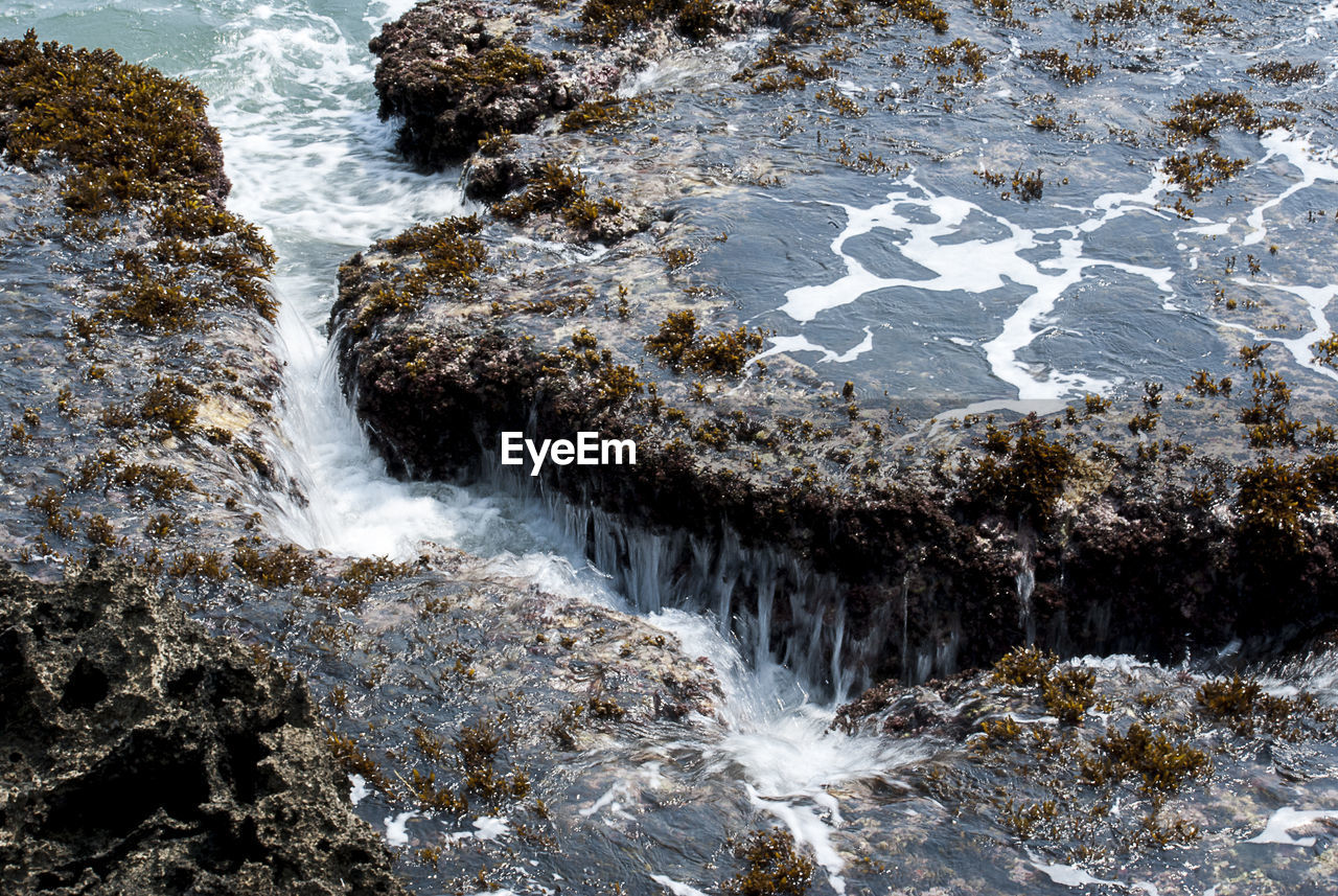 Water flowing through rocks in sea