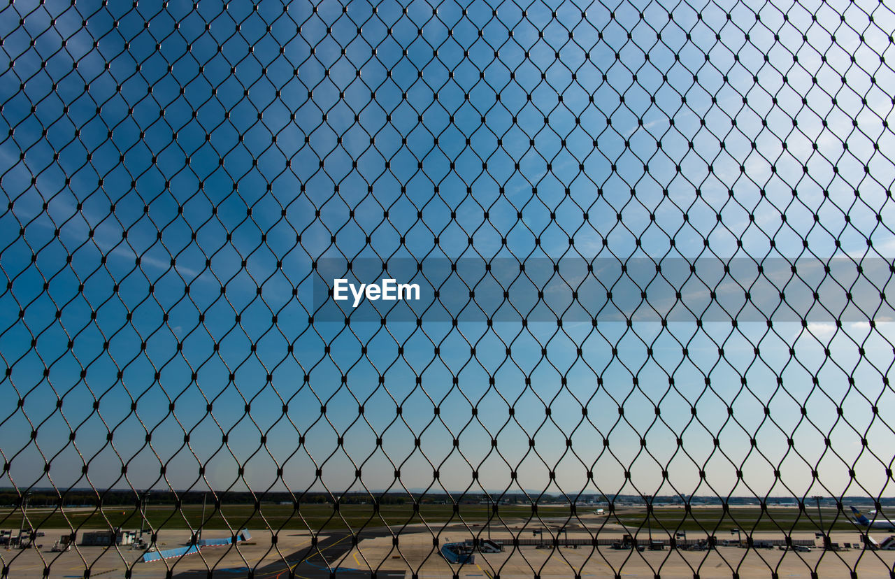 CHAINLINK FENCE AGAINST CLEAR SKY