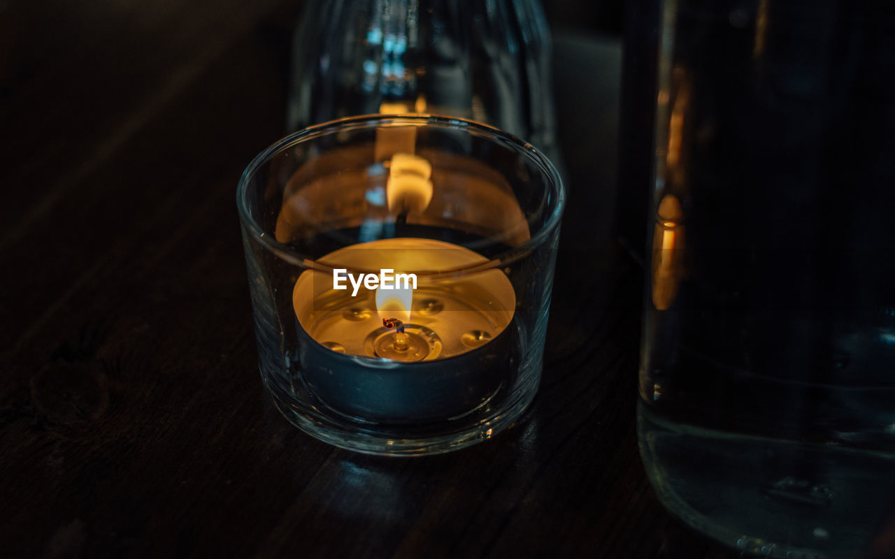 High angle view of lit tea light on table