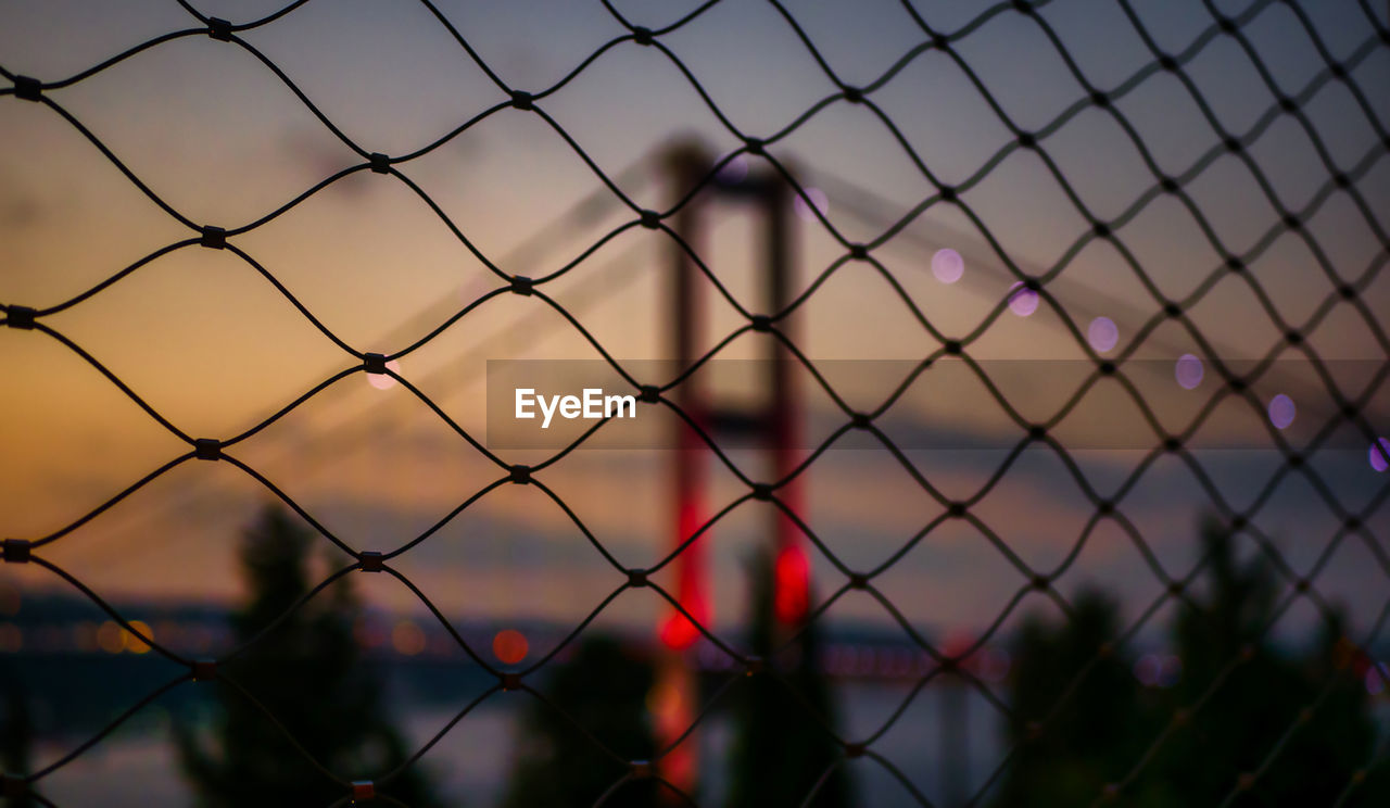 Bosporus bridge at evening, democracy and national unity day turkey, close-up of chainlink fence