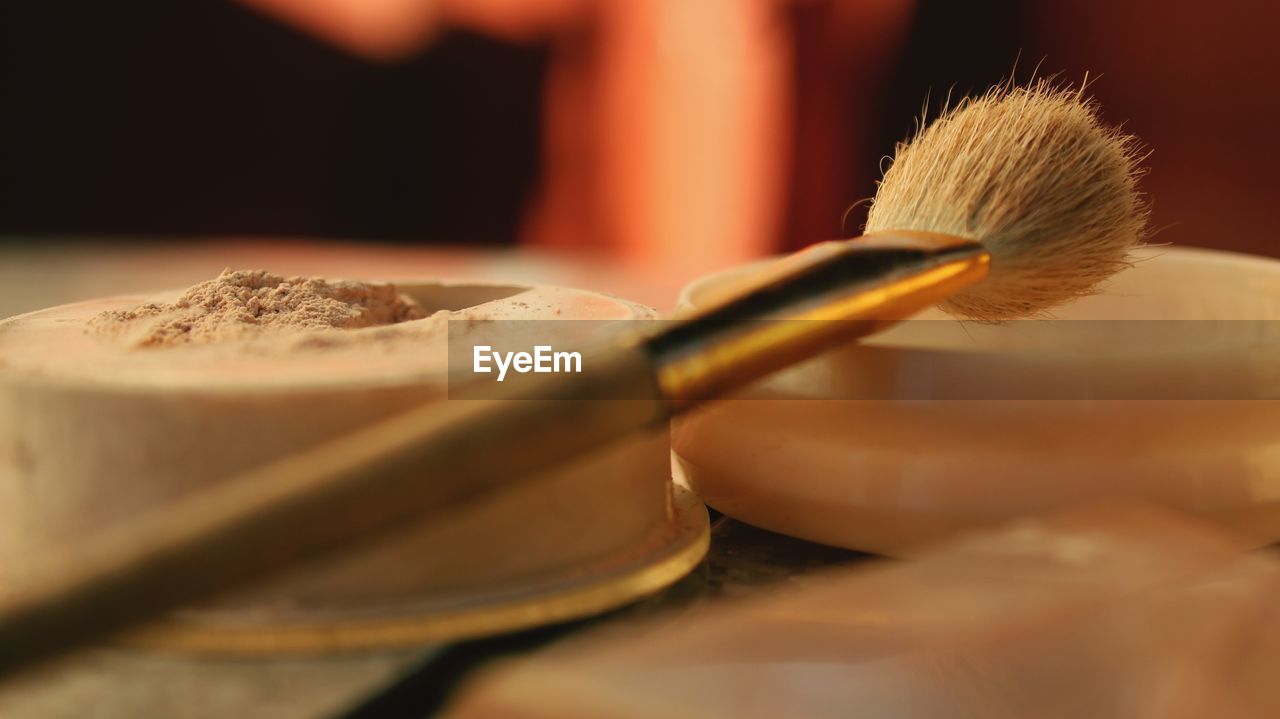 Close-up of make-up brush and powder