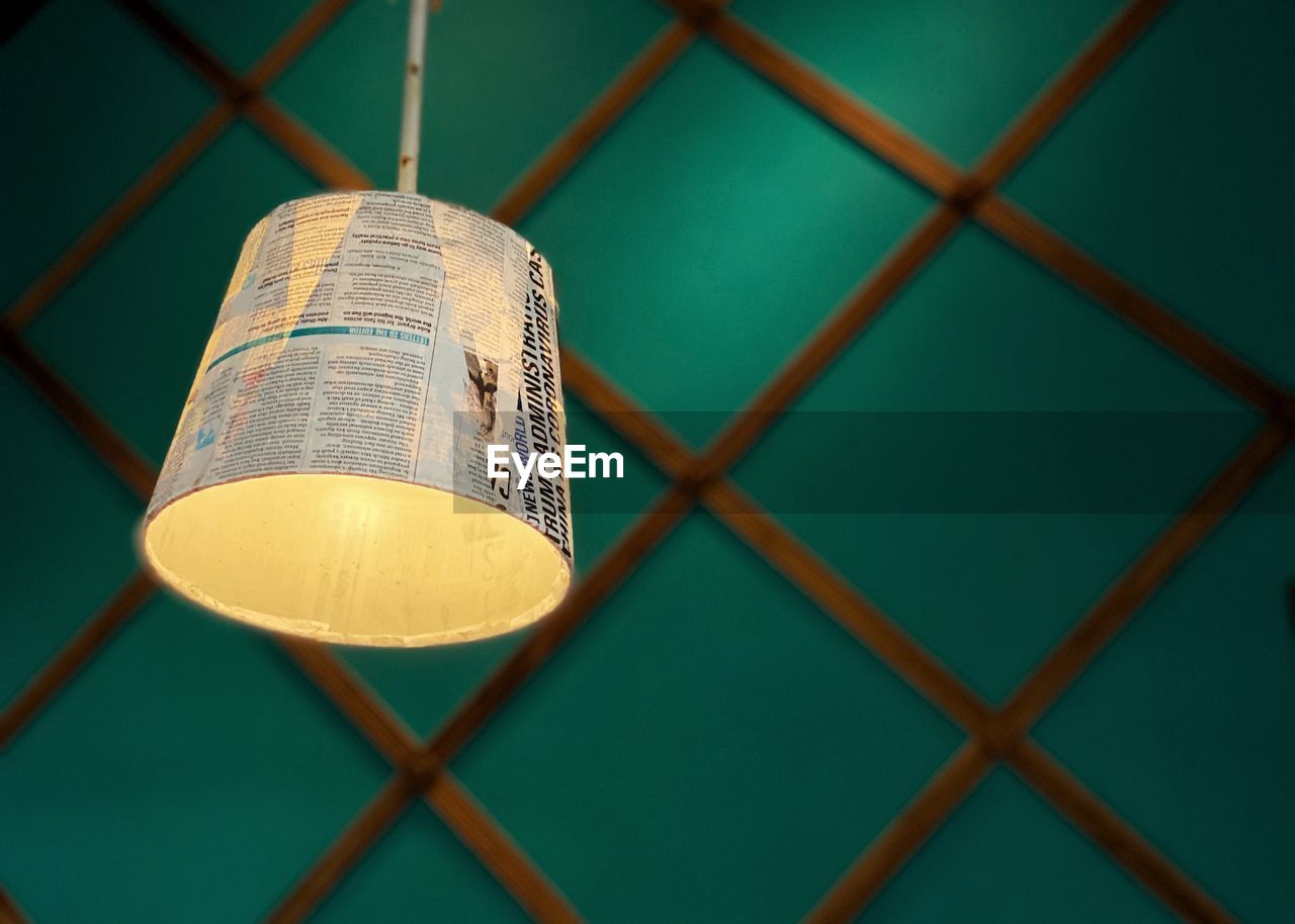 Close-up of text hanging on chainlink fence