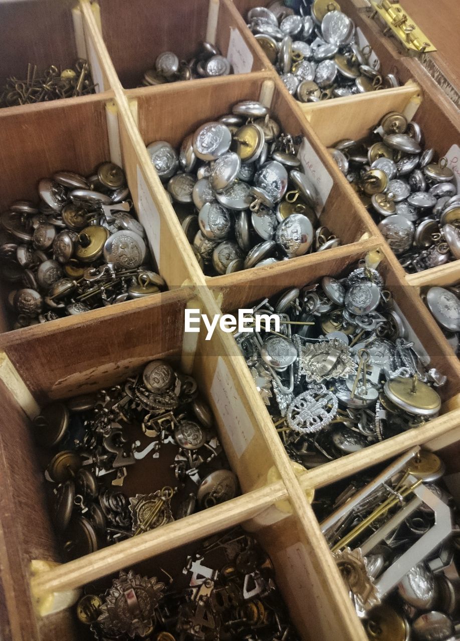 High angle view of buttons in wooden box