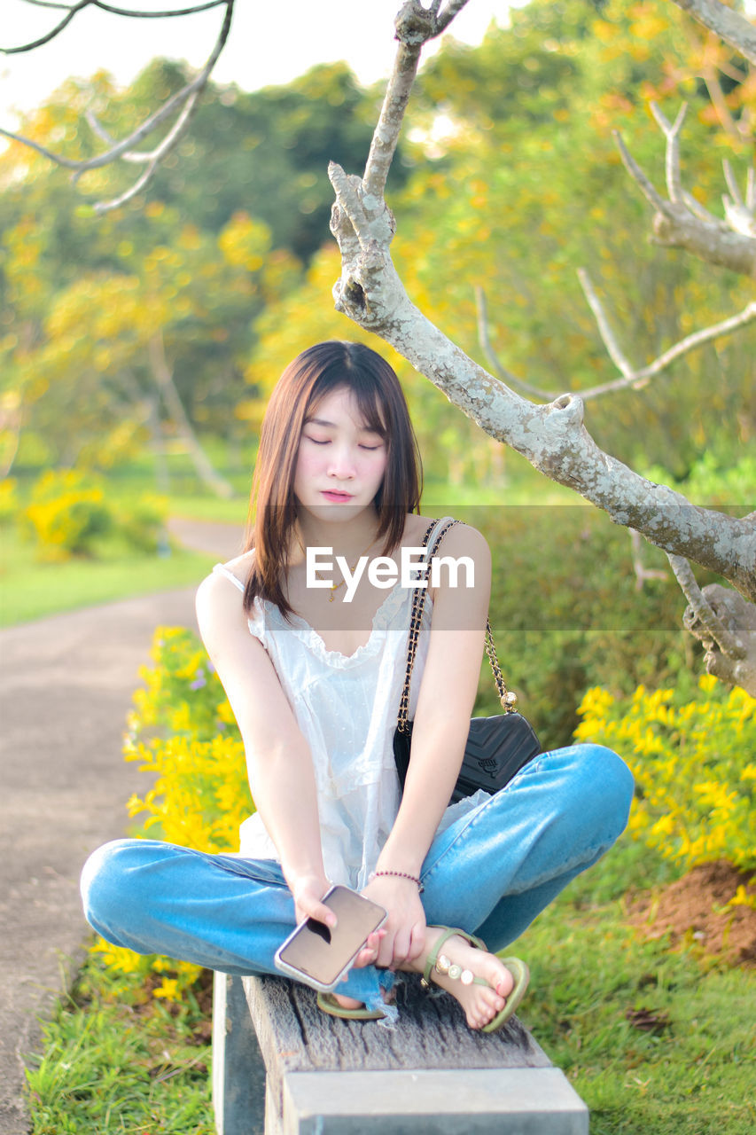 Young woman sitting on field