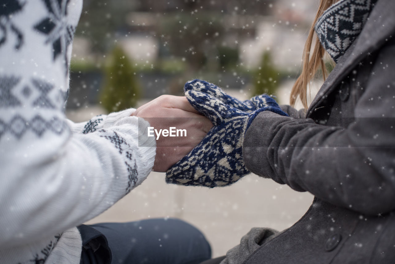 Close-up of woman hand in snowy weather
