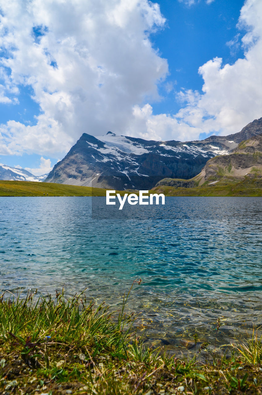 Scenic view of lake and mountains against sky