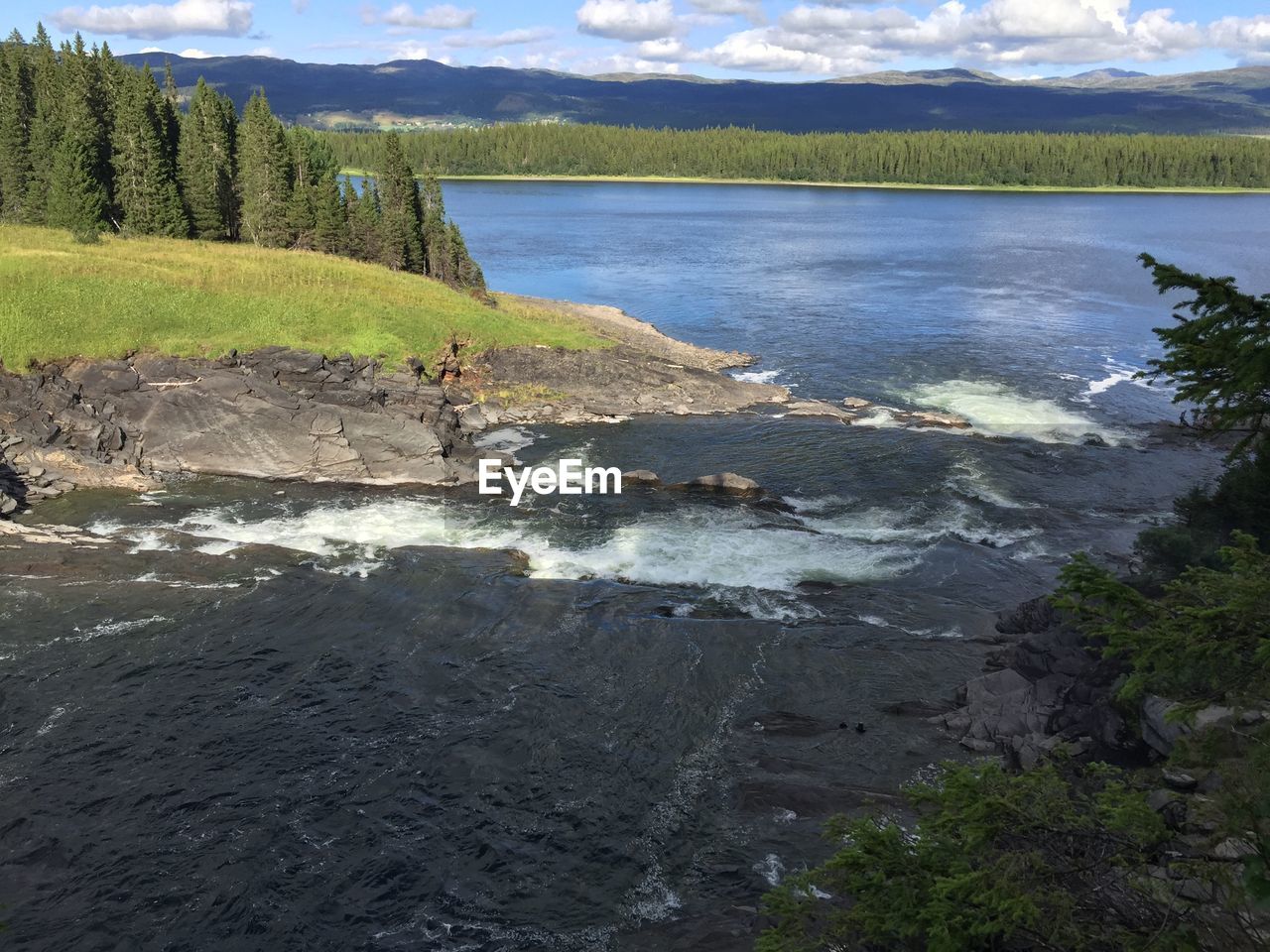 SCENIC VIEW OF RIVER FLOWING THROUGH LAND