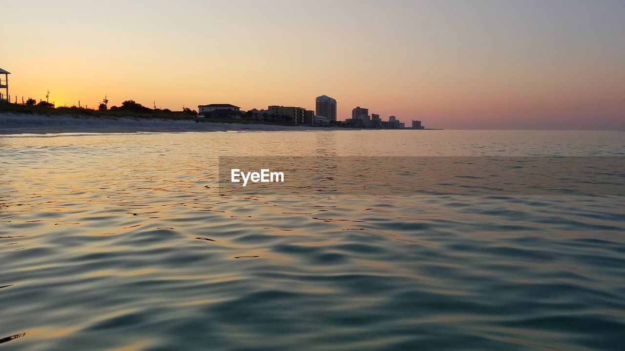 Scenic view of sea against clear sky during sunset