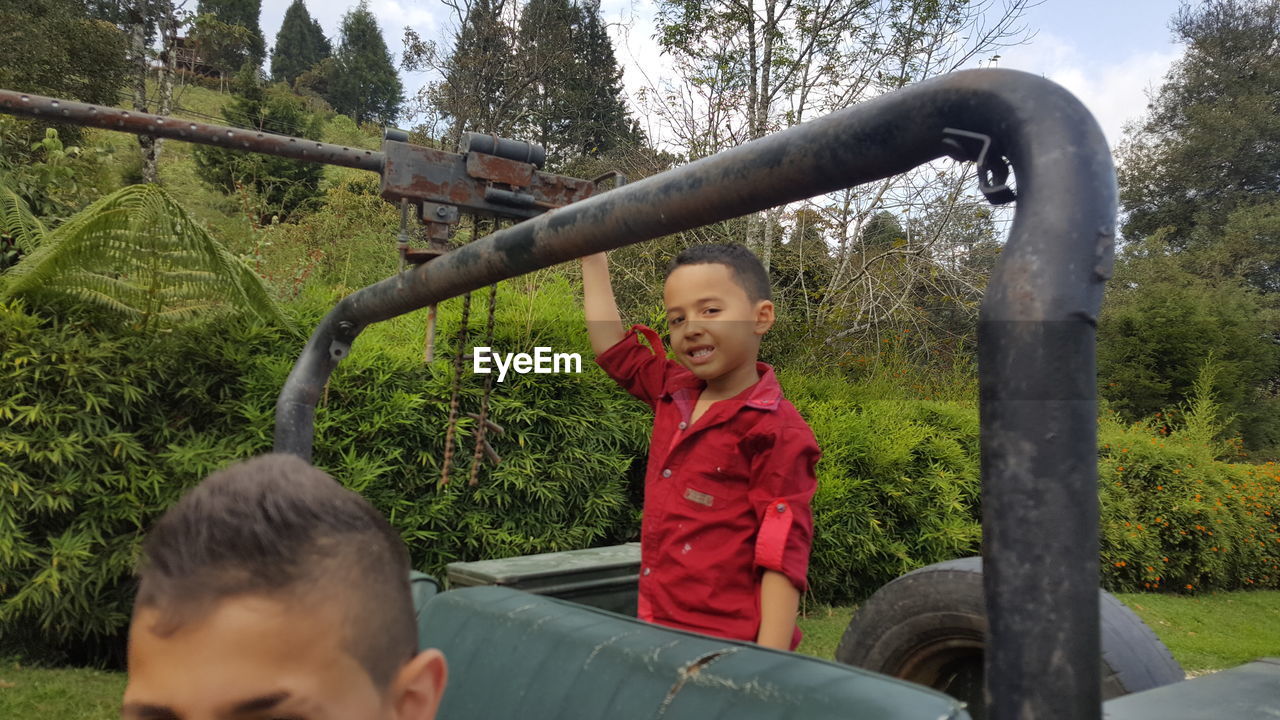 CUTE BOY PLAYING ON SLIDE AT PARK