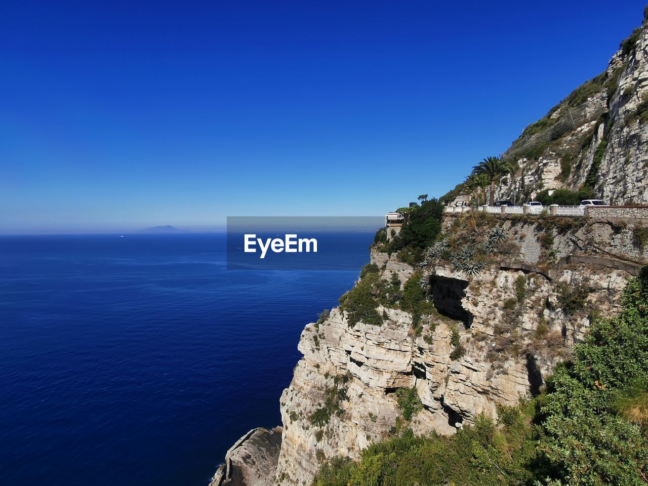 Scenic view of sea against clear blue sky