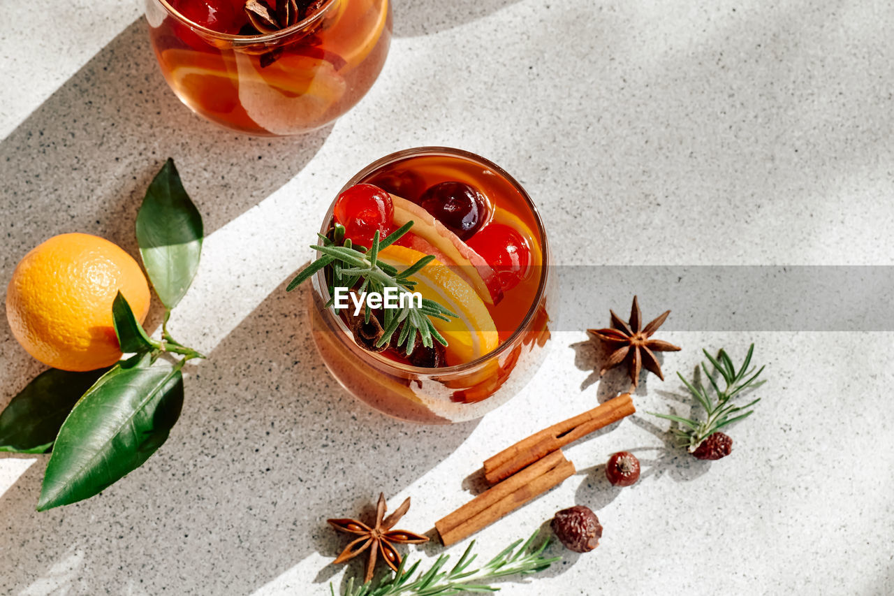 Mulled wine or christmas sangria with aromatic spices, apple, cherry and citrus fruits.