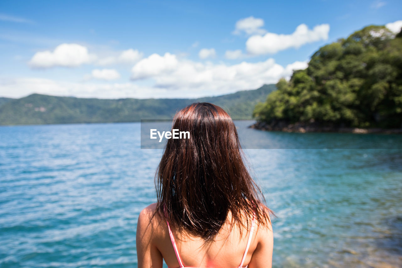 Rear view of woman looking at lake