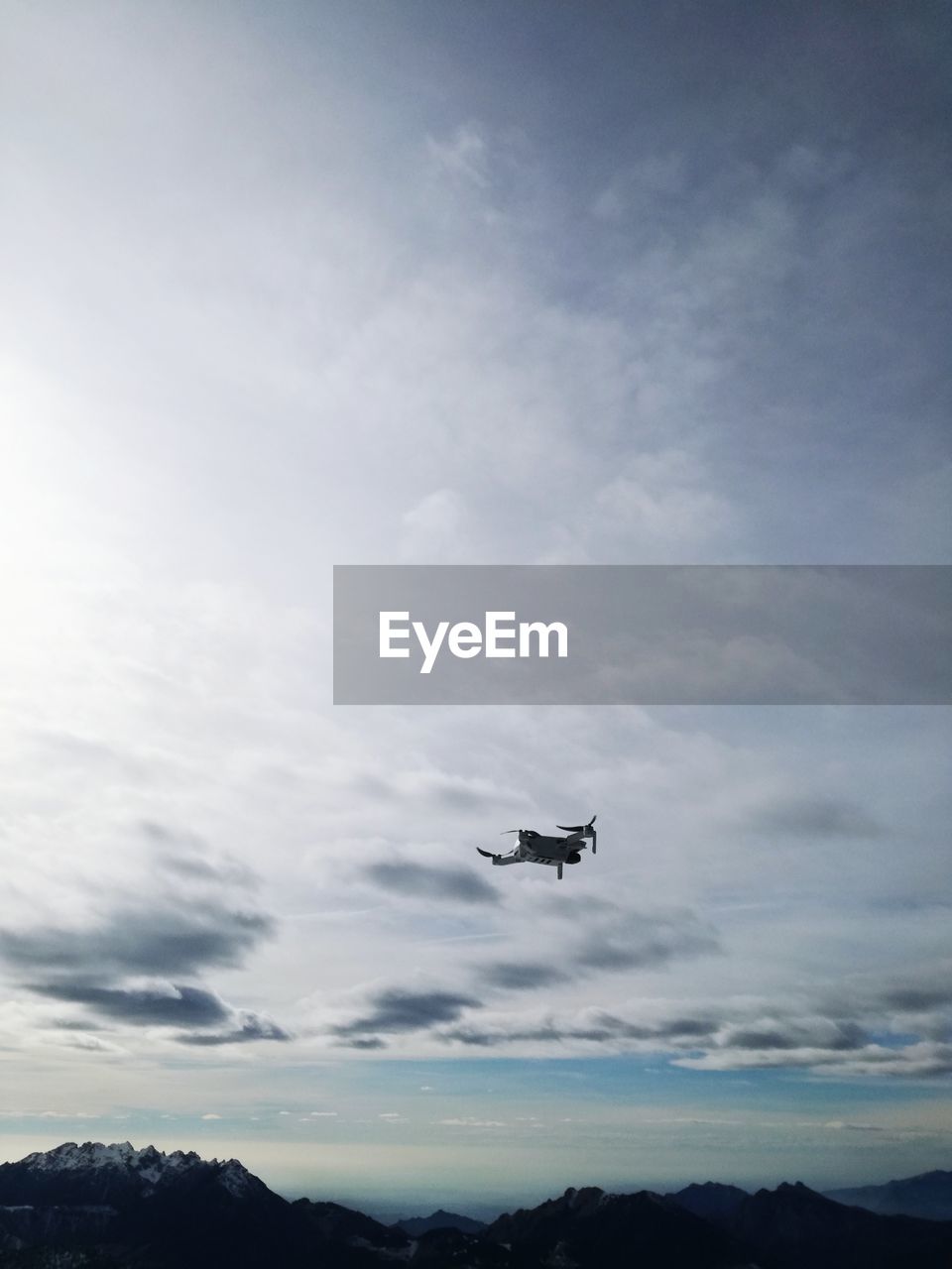 Low angle view of airplane flying against sky