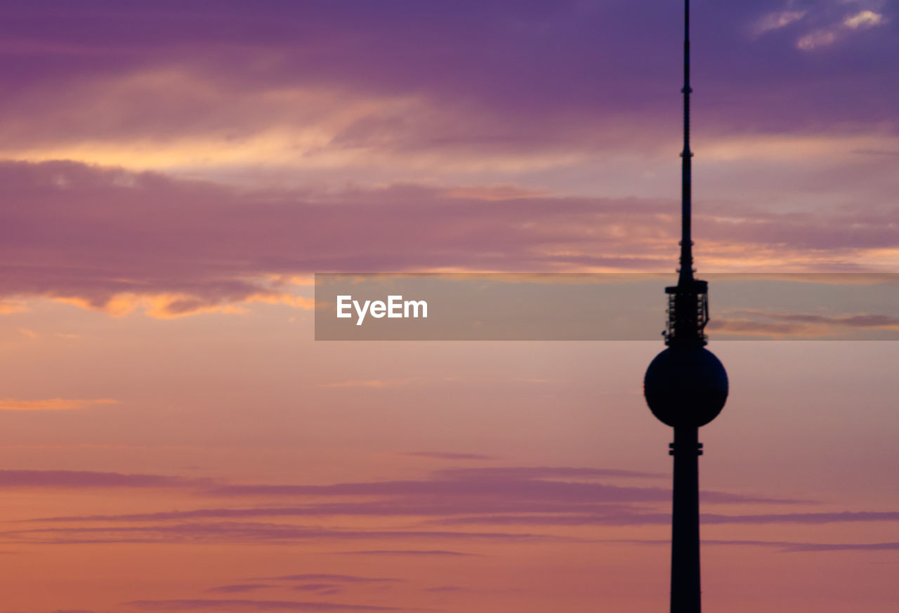 Low angle view of silhouette tower against sky during sunset