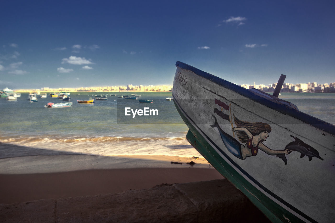 BOAT MOORED ON BEACH