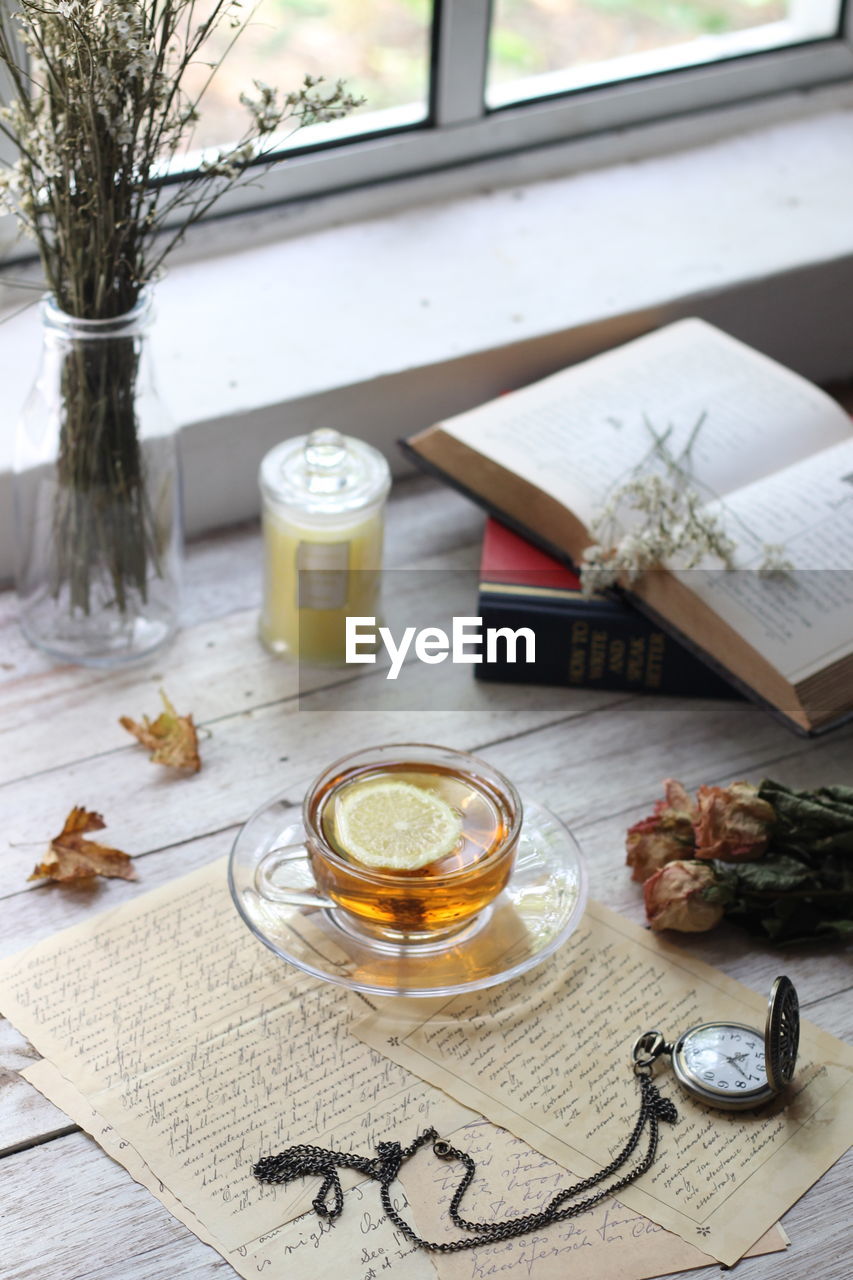 HIGH ANGLE VIEW OF GLASSES ON TABLE AT HOME