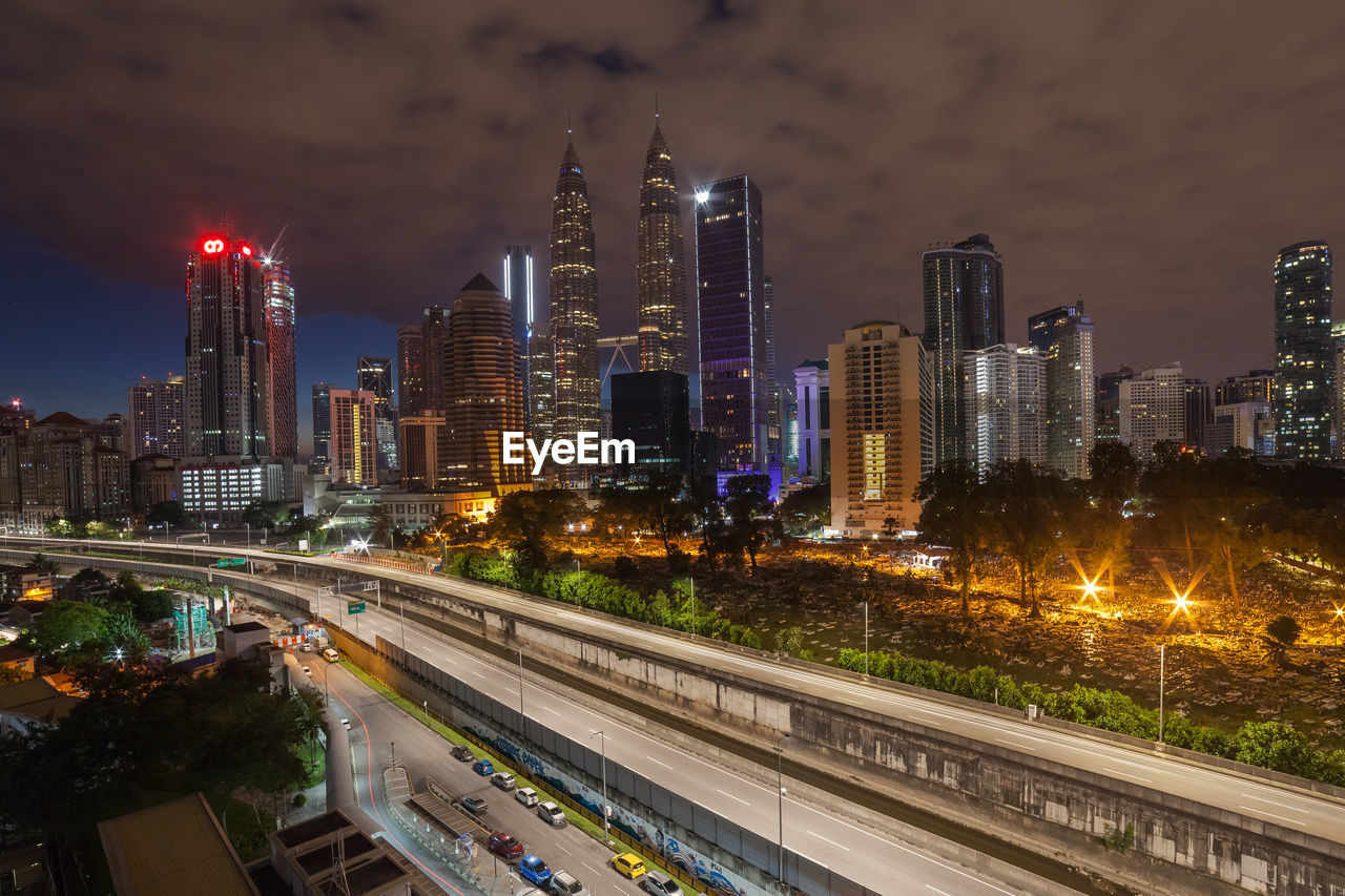 ILLUMINATED CITY BUILDINGS AT NIGHT