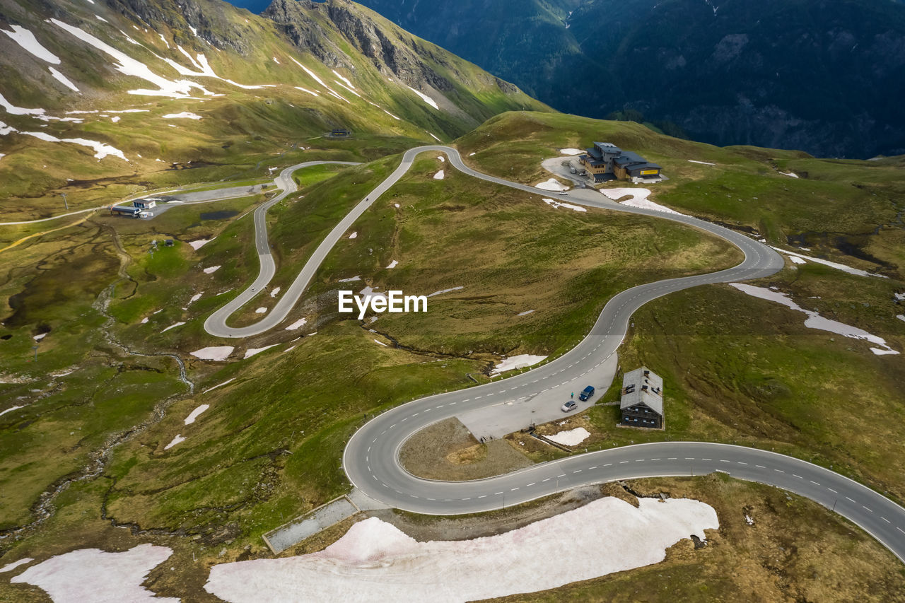 HIGH ANGLE VIEW OF ROAD BY MOUNTAIN