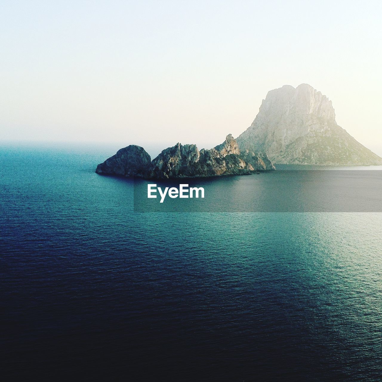 Rock formation amidst sea against sky