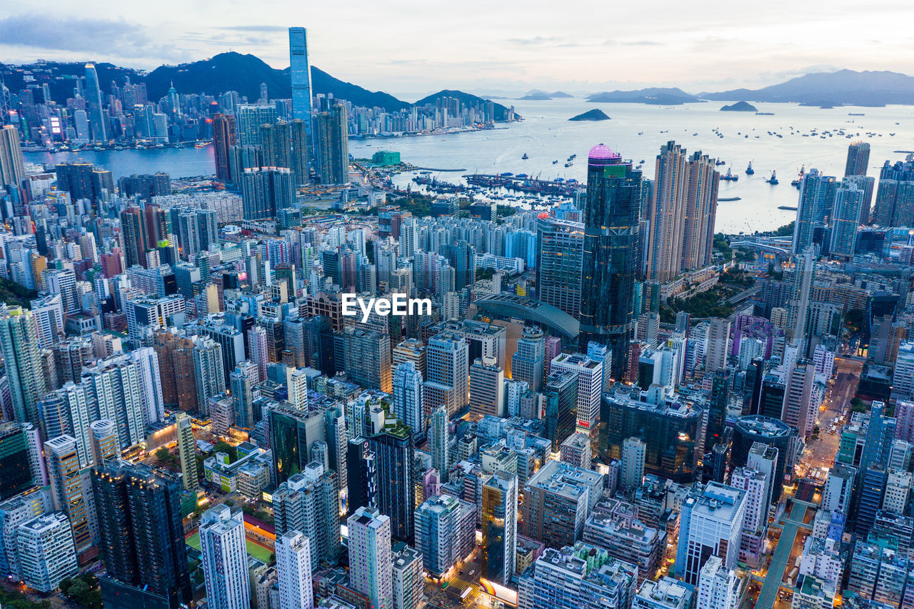 Aerial view of buildings in city against sky at dusk