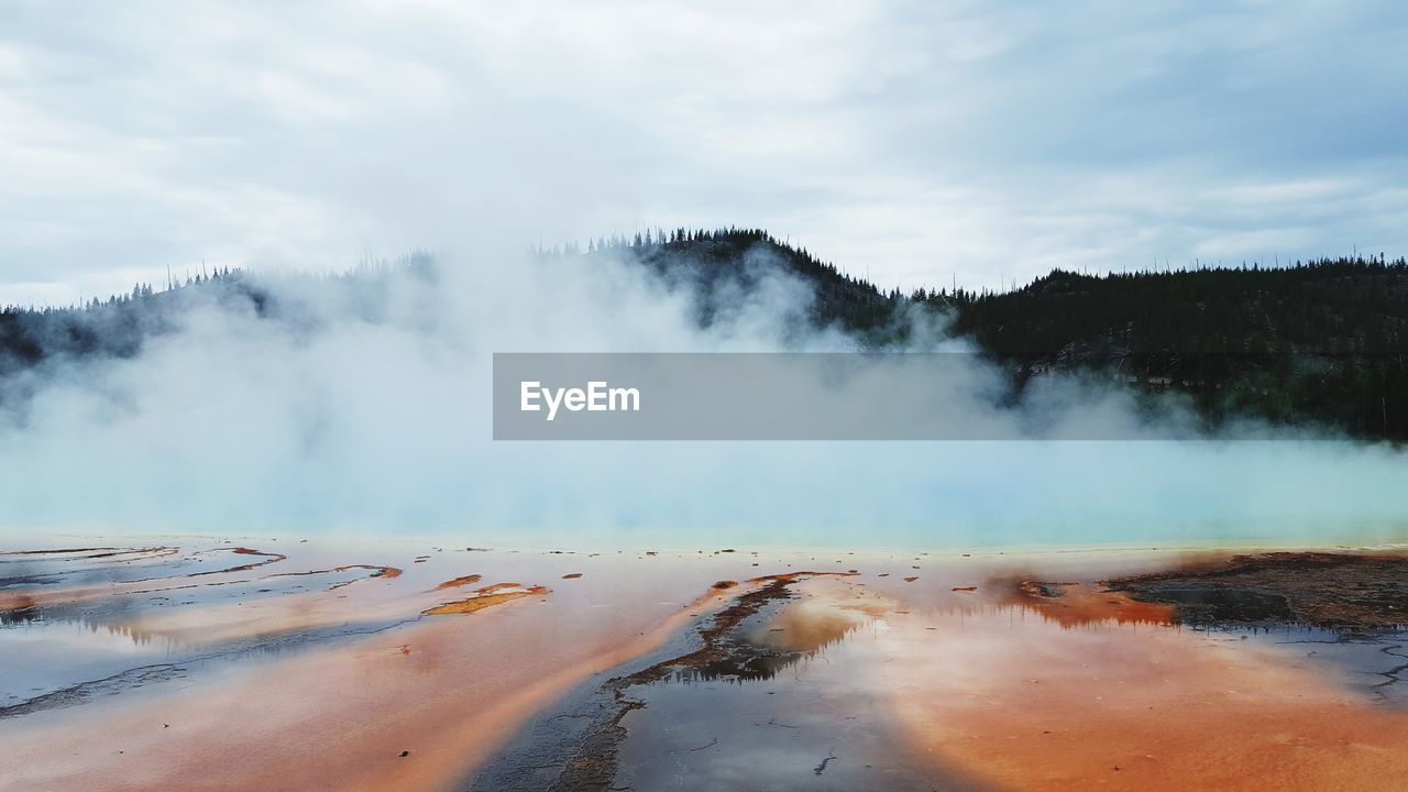 Scenic view of steam emitting from landscape