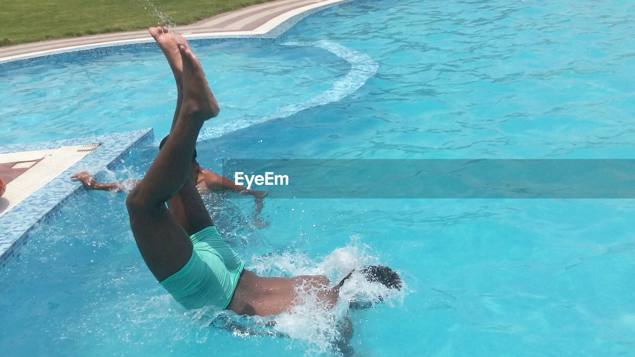 High angle view of man diving into swimming pool