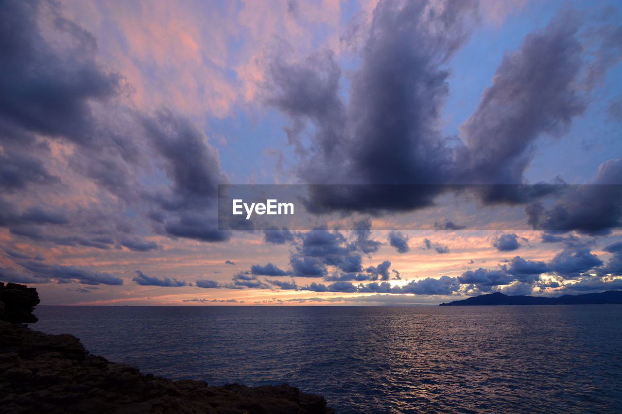 Scenic view of sea against sky at sunset