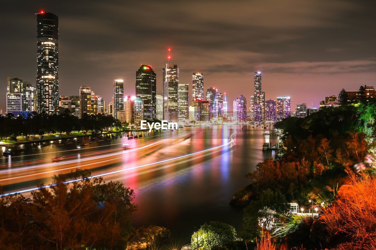 ILLUMINATED MODERN BUILDINGS IN CITY AT NIGHT