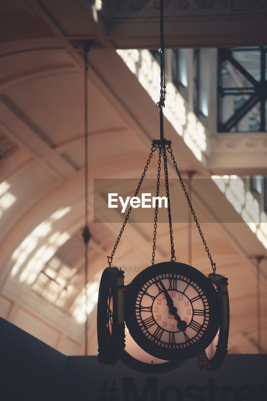 Close-up of clock hanging on ceiling