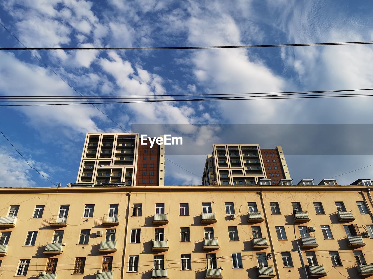 LOW ANGLE VIEW OF RESIDENTIAL BUILDINGS AGAINST SKY