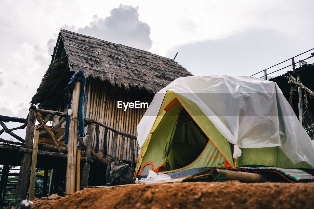 LOW ANGLE VIEW OF TENT ON BUILDING AGAINST SKY