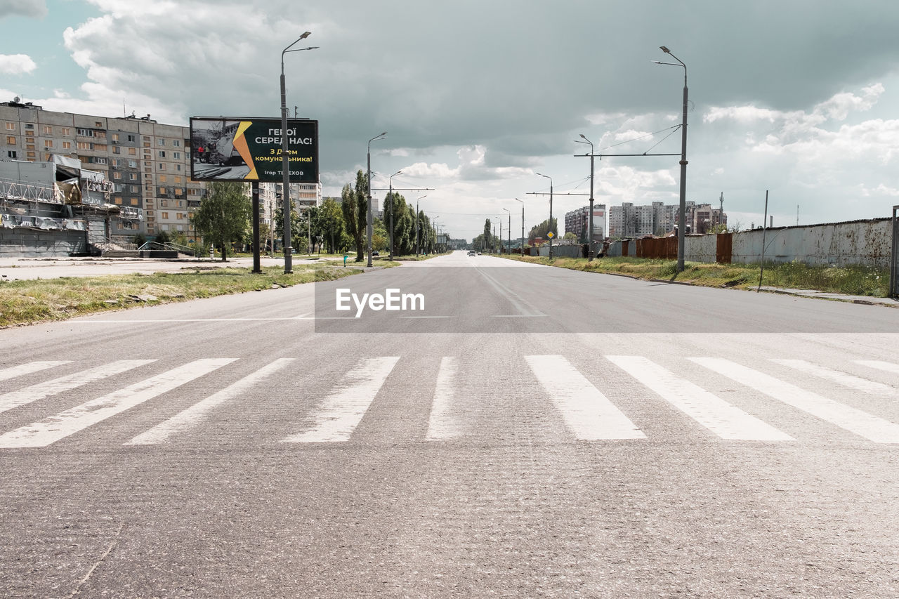 empty road by street against sky