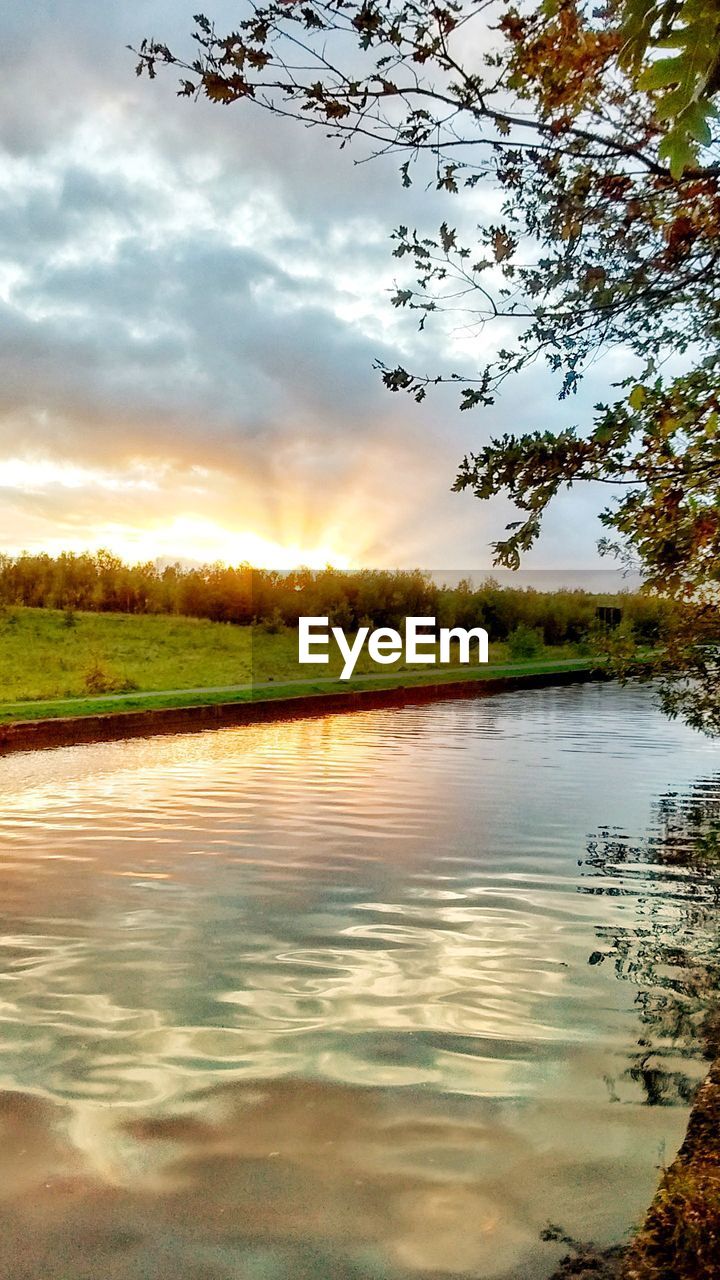 LAKE AGAINST SKY AT SUNSET