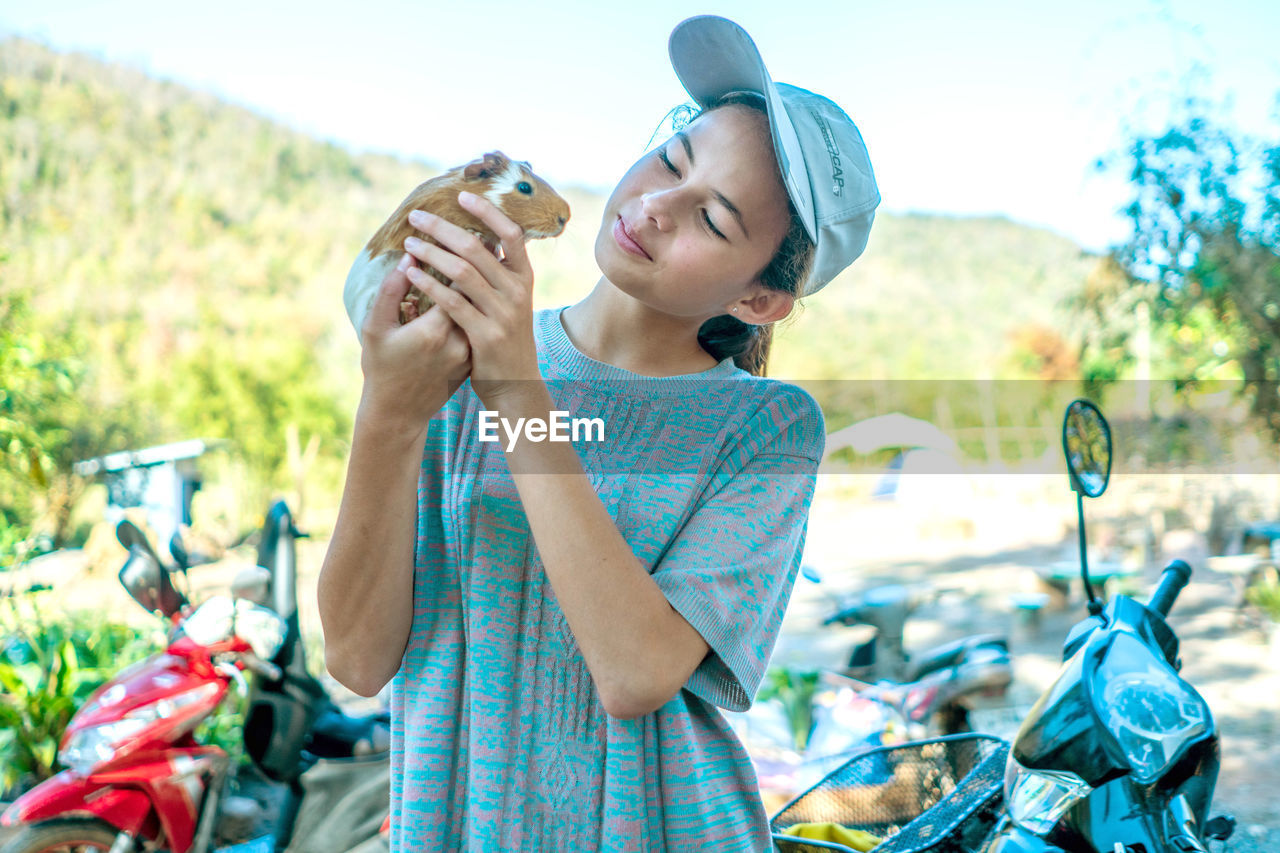 Friendship, girl and mammal, beautiful white girl holding guinea pig, cute relationship