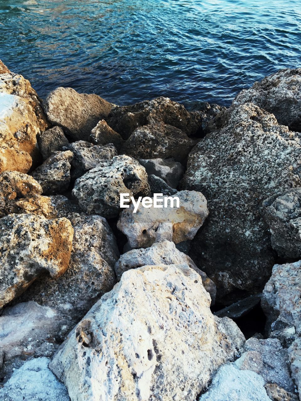 High angle view of rocks by sea