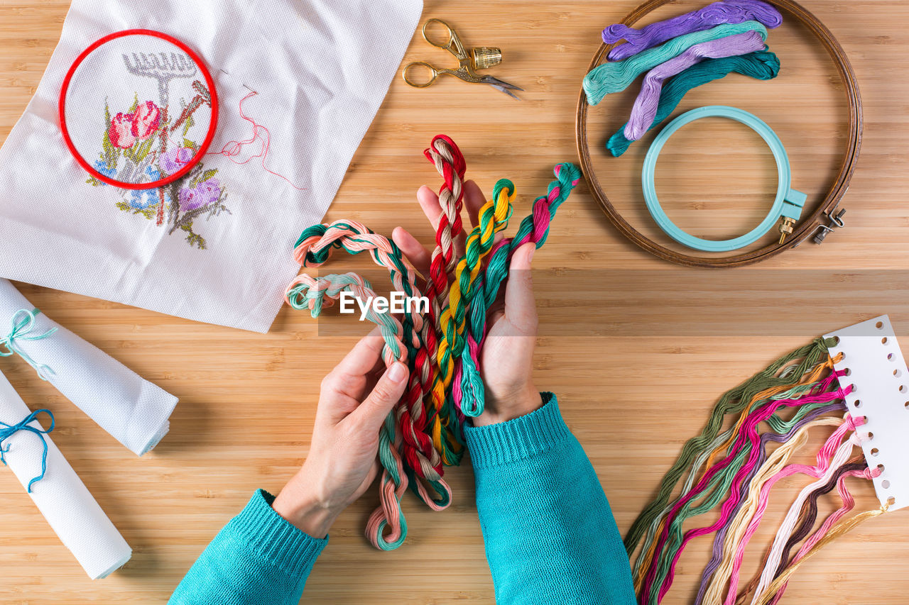 Directly above view of intertwined multi colored wool on table