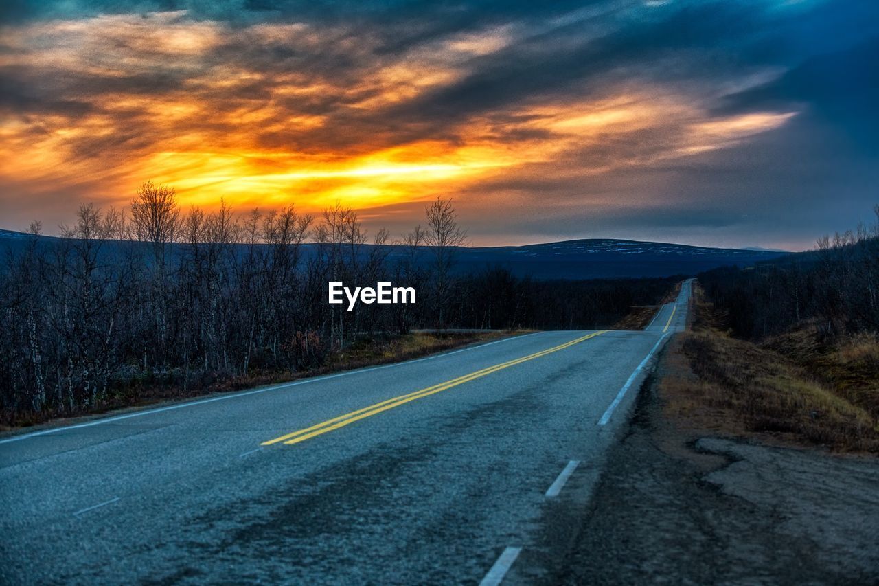 COUNTRY ROAD AGAINST SUNSET SKY