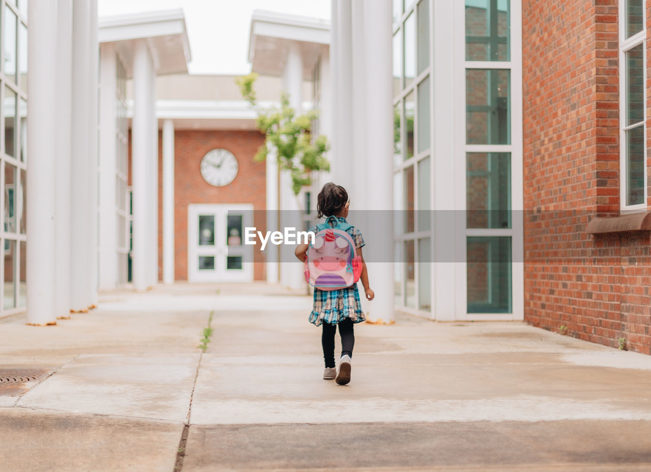 Diverse mixed race pre school age girl heading back to school after summer break