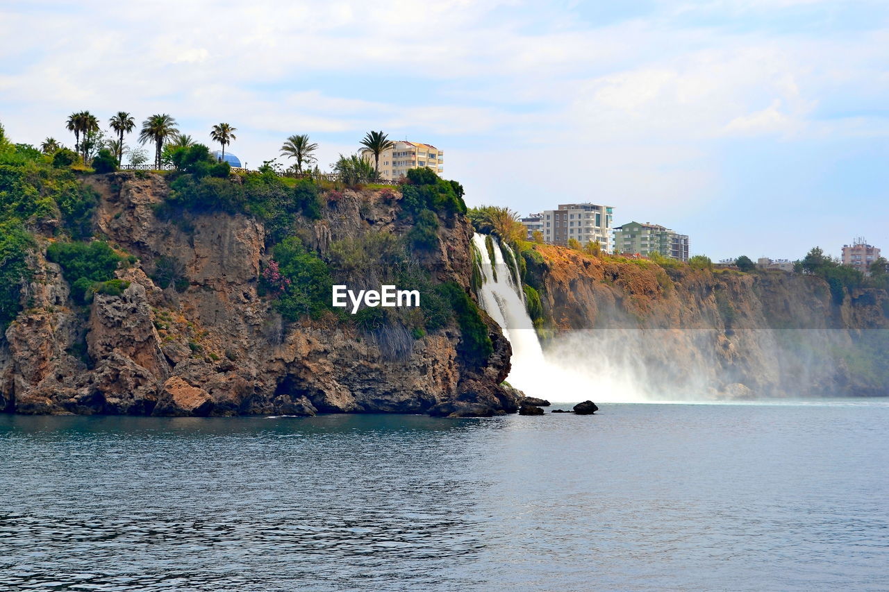 Scenic view of rocks in sea against sky