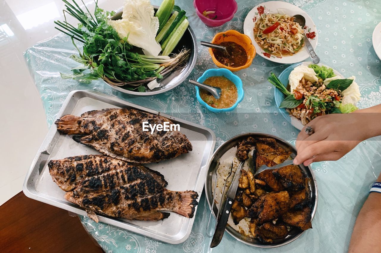 High angle view of person preparing thai food on table