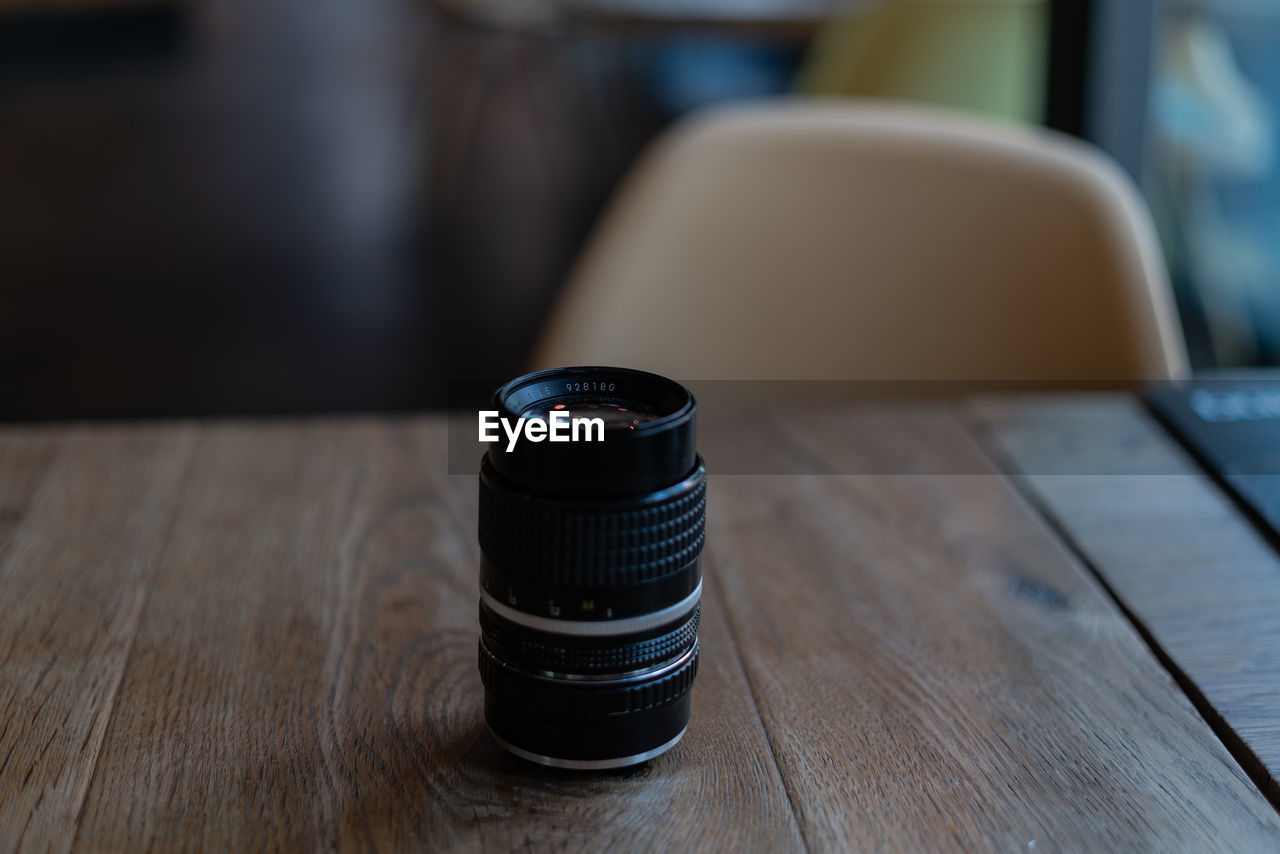 Close-up of lens on wooden table