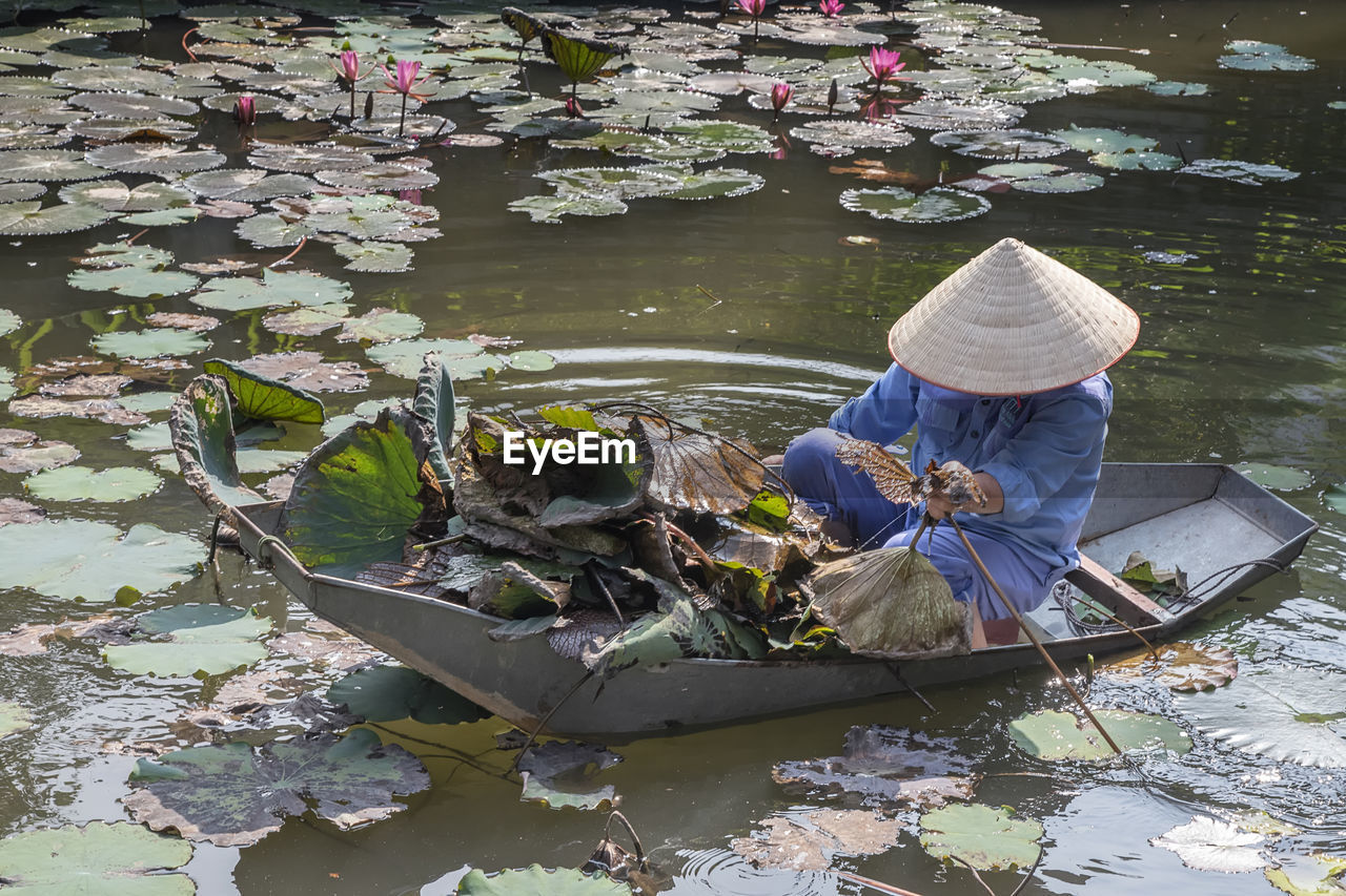 High angle view of woman sitting in rowboat