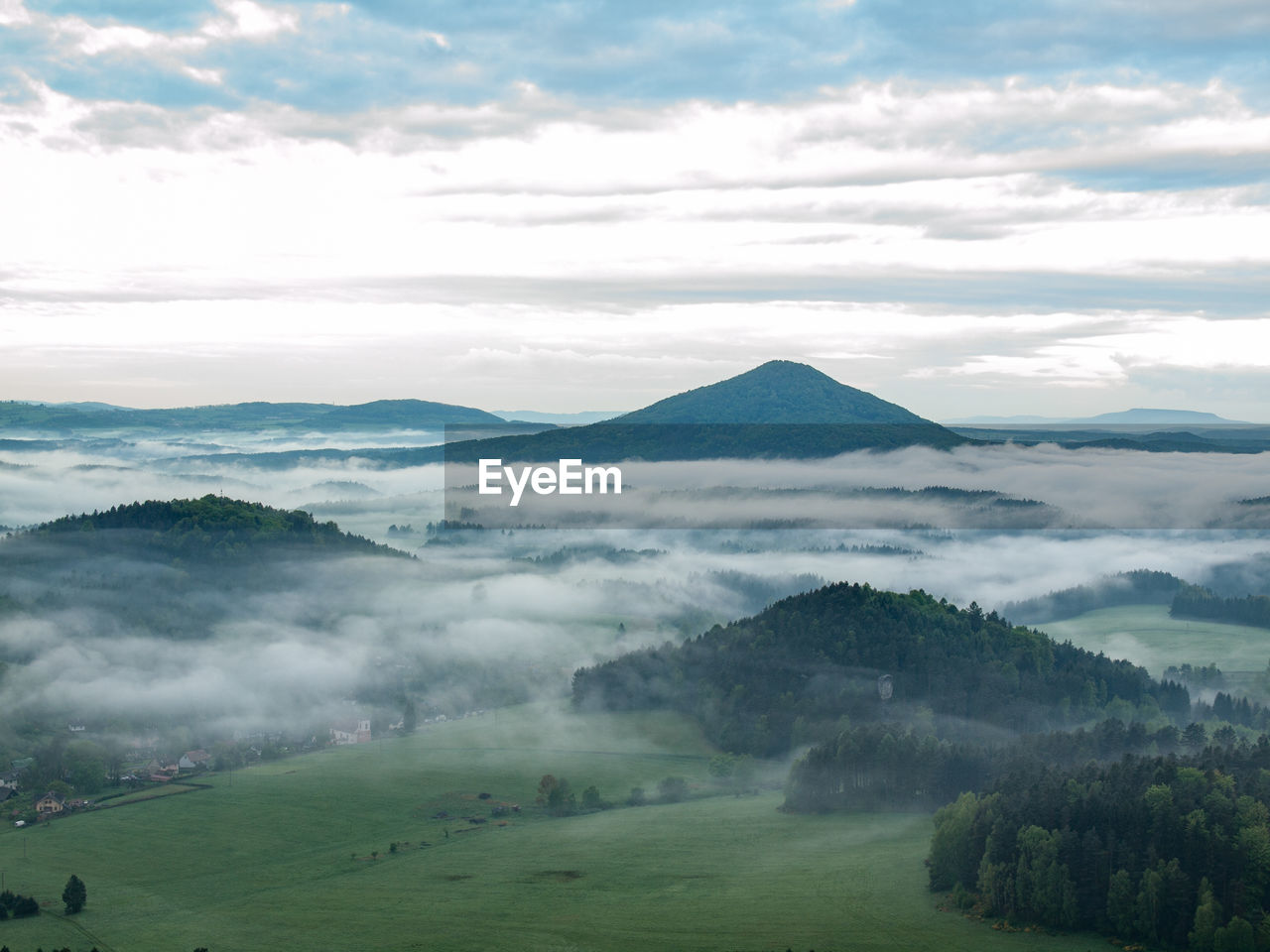 Scenic view of mountains valley with autumn fall against dark sky