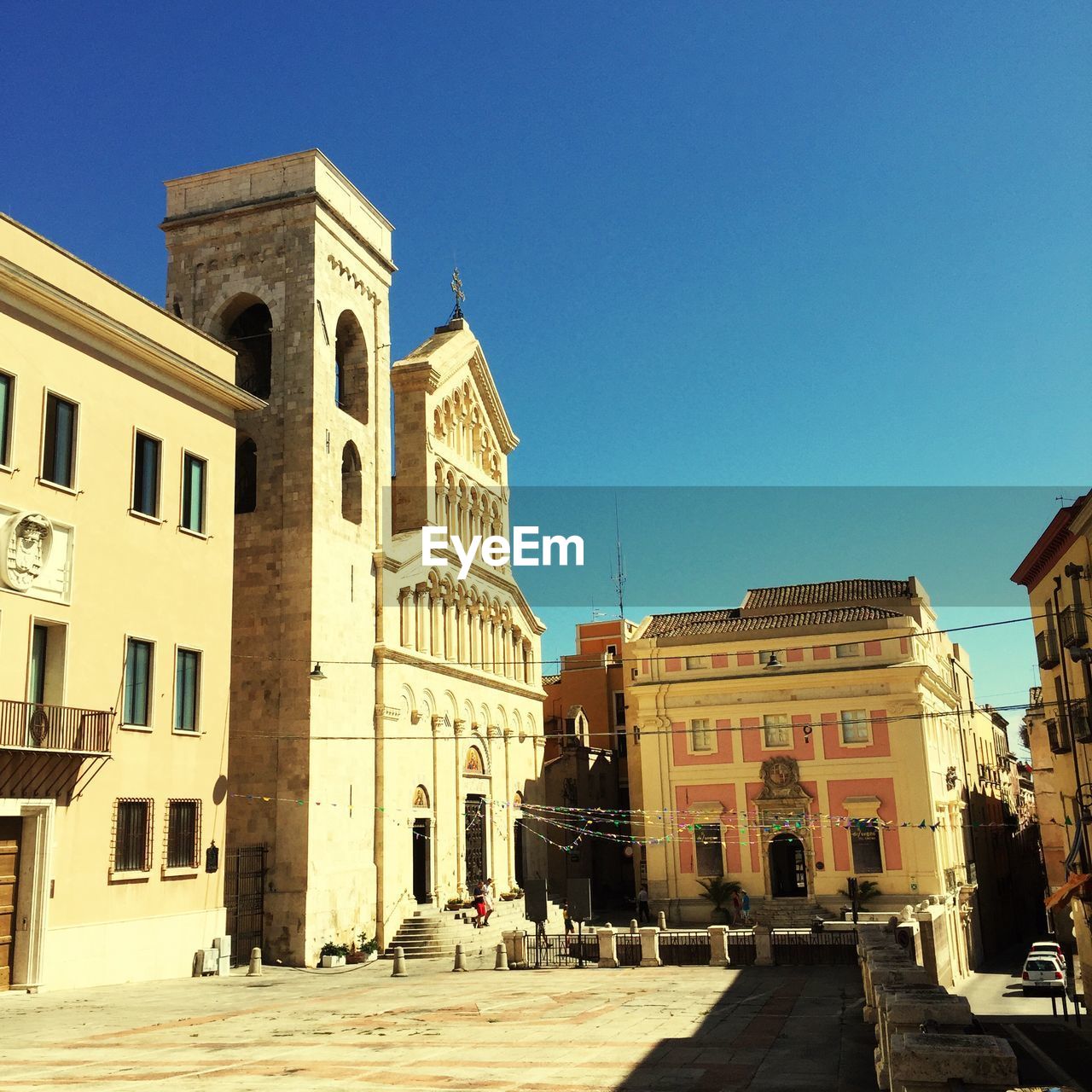 Buildings in town against clear blue sky